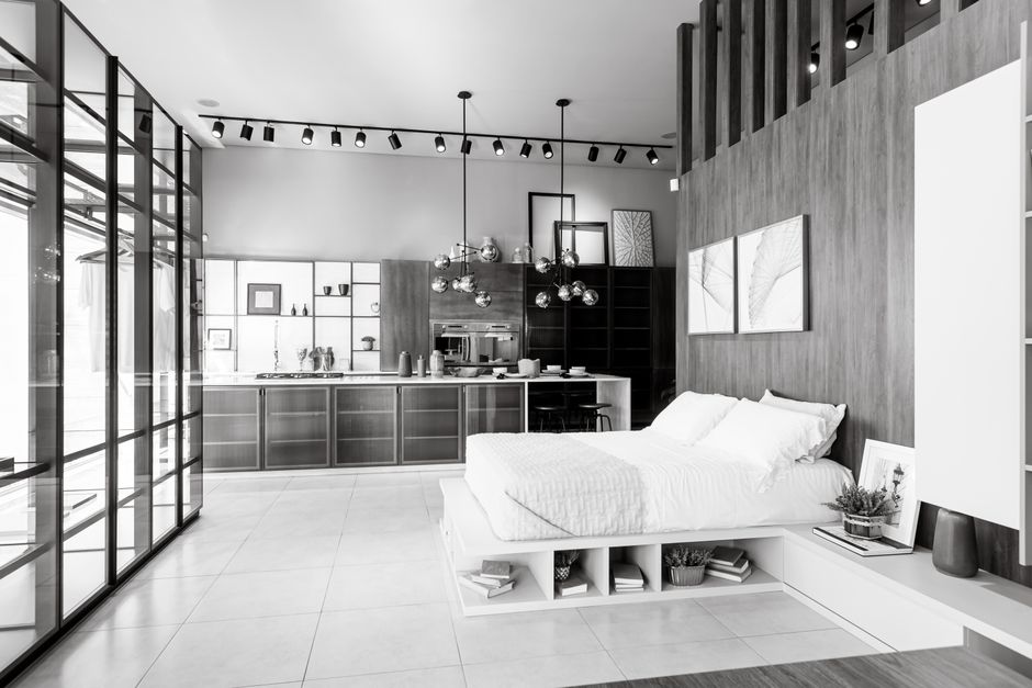 Elegant interior featuring a minimalist bedroom adjacent to a contemporary kitchen.